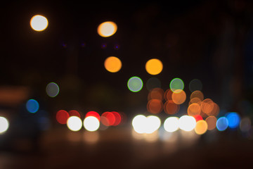 Bokeh blur of car lights on street at night.
