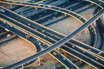 Highway roads with traffic in big city (Dubai) viewed from sky