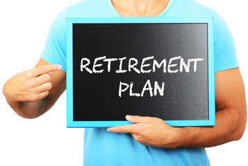 Man holding blackboard in hands and pointing the word RETIREMENT