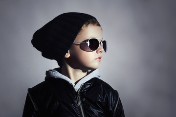 Fashion child boy in sunglasses.Underground background.boy