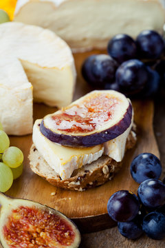 Breakfast setting with bread, cheese, figs and honey