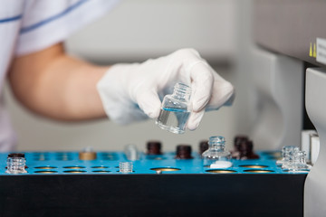 Researcher Loading Samples Into Analyzer
