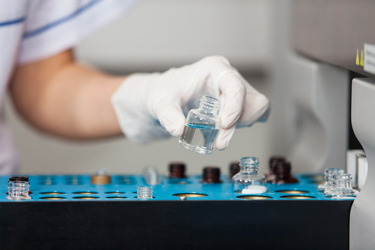 Researcher Loading Samples Into Analyzer