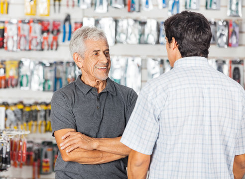 Man Conserving With Son In Hardware Store