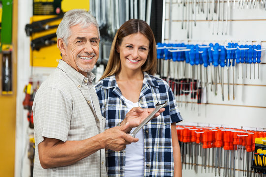 Father And Daughter With Wrench In Shop