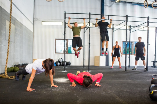Athletes Exercising In Gym