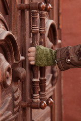 Hand holding the handle of an old door