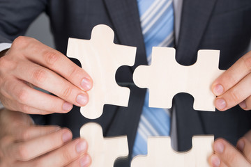 Hands connecting puzzle pices