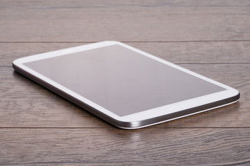 Modern tablet on wooden table