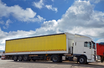 white truck and yellow trailer