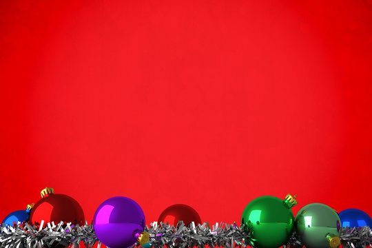 Composite image of christmas baubles and tinsel