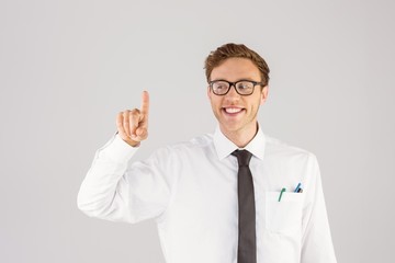 Geeky businessman smiling and pointing