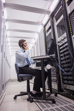 Technician talking on phone while looking servers