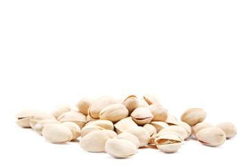 Pistachios heap against white background.