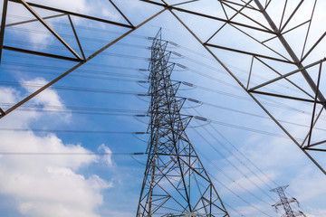 Fototapeta premium High voltage power pole and electricity line with blue sky backg