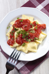 Portion of ravioli with tomato sauce