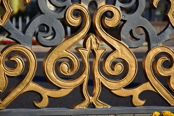 Bronze-painted pattern on a fence