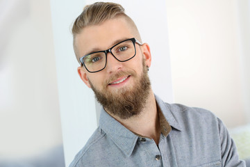 Obraz premium Portrait of cheerful trendy young man