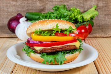 close up of homemade hamburger on white plate