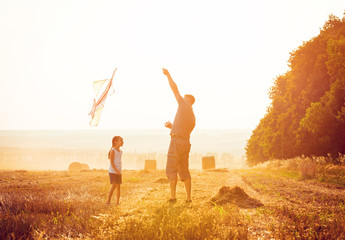 Dad with his little daughter let a kite