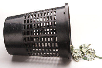 Money in basket. Dollars in the trash bin