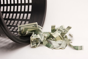 Money in basket. Dollars in the trash bin