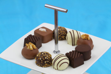 Selection of chocolates on white cake tray