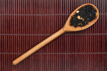Wooden spoon with black tea