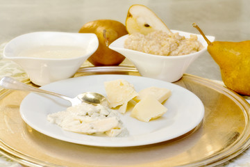 cheese selection in the foreground with pear cream in the backgr
