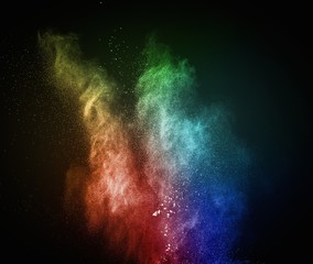 Colourful powder exploding isolated on black