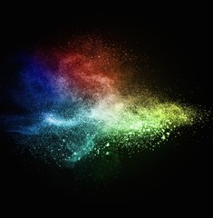 Colourful powder exploding isolated on black