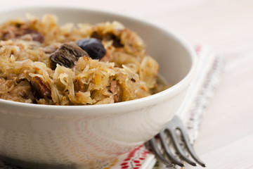 traditional polish sauerkraut (bigos) with mushrooms and plums