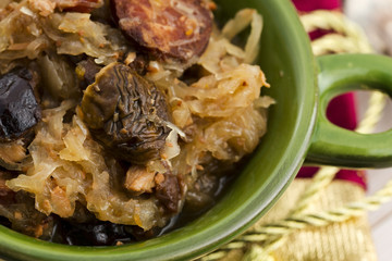 traditional polish sauerkraut (bigos) with mushrooms and plums