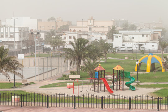 Dust storm. Playground with palms, Saudi Arabia