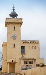 Fototapeta na wymiar Yellow lighthouse tower. Cap Malabata, Tangier, Morocco