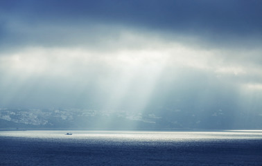 Bay of Tangier, Morocco. Sunlight goes through stormy clouds