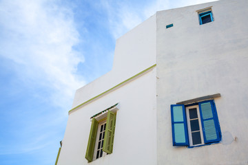 White wall with windows and blue sky. Medina, old part of Tangie