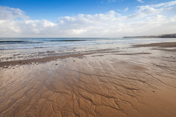 Atlantic ocean coast, wet sand and blue sky, Tangier, Morocco