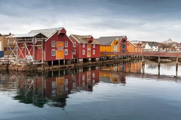 Muurstickers Red and yellow wooden houses in Norwegian village © evannovostro
