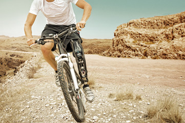 Handicapped mountain bike rider barren landscape