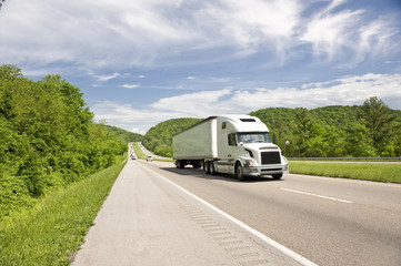 Fototapeta na wymiar White Semi Truck On Highway In Springtime