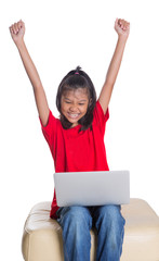 Young Asian girl with a laptop raising her arms 