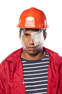 Sad Dark-skinned Worker With Helmet And Injured Eye