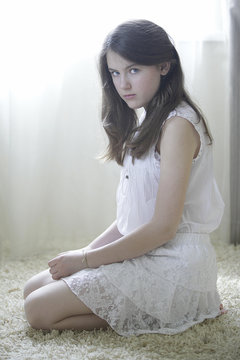 Young beautiful girl sitting on the floor