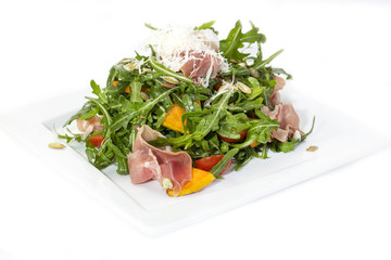 salad of arugula ham cheese on a white background