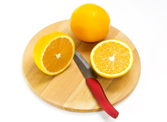 orange on a cutting board and knife