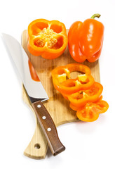 pepper on a cutting board and knife