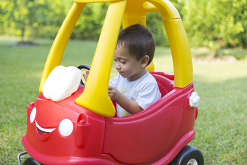 Fototapeta na wymiar Happy Little Boy Driving His Toy