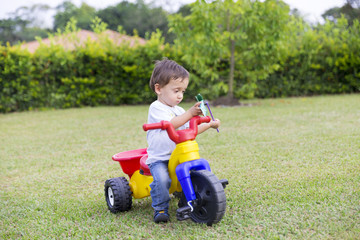 Happy Little Boy Driving His Toy