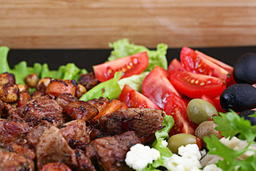 grilled meat on a plate served with vegetables